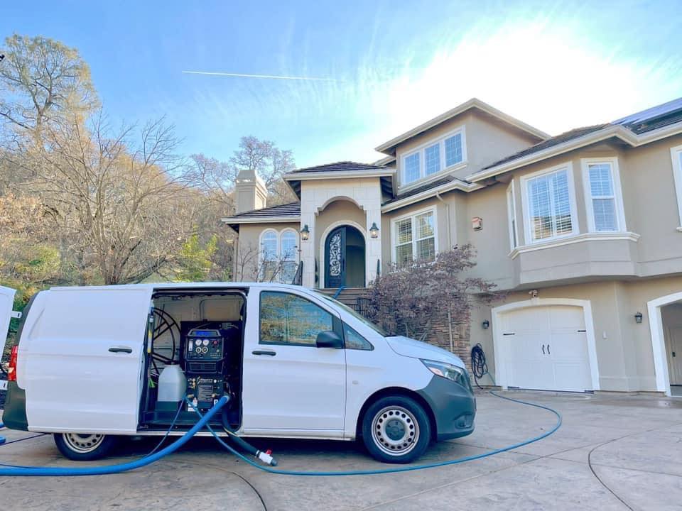Mike's Carpet Cleaning Plus van in front of a residential home